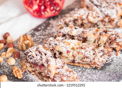 Puff Pastry Plait With Chocolate Cream, Walnuts, Hazelnuts And Pomegranate Seeds.