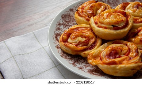 Puff Pastry Snails, With Cheese And Ham On A Plate