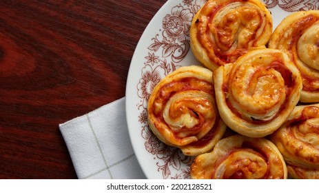 Puff Pastry Snails, With Cheese And Ham On A Plate