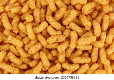 Puffed corn and peanuts snacks. Background and texture, full frame.