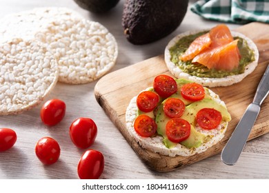 Puffed Rice Cake With Avocado And Tomato On Wooden Table