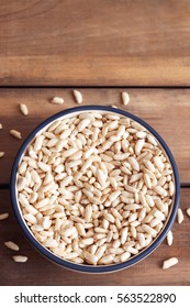 Puffed Rice Cereal In Bowl On Wooden Background. Top View With Copy Space