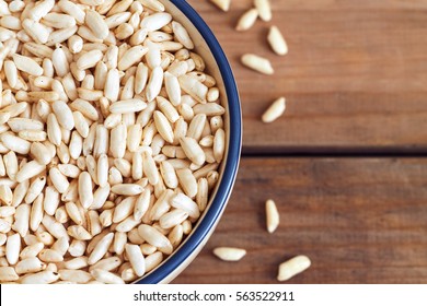 Puffed Rice Cereal In Bowl On Wooden Background. Top View With Copy Space