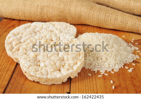 Puffed ricecakes with long grain white rice on a rustic wood table