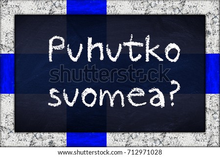 puhutko suomea (translation: do you speak finnish) language education concept on chalkboard blackboard with wooden finnland flag frame