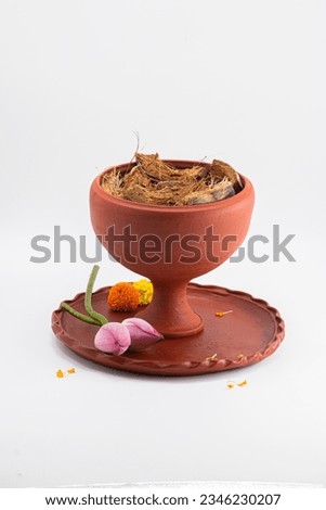 PUJA DHUNUCHI WITH CLAY THALI AND LOTUS. ISOLATED ON WHITE BACKGROUND. SELECTIVE FOCUS.