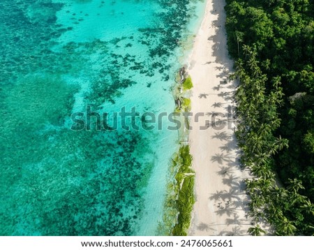 Puka Shell Beach. Clear turquoise water and ocean waves on sand. Boracay, Philippines.