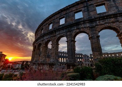 Pula Amphitheater at sunset, also known as Coliseum of Pula, is a well-preserved Roman amphitheater in Pula, Istria, Croatia. An ancient arena of the Roman Empire.