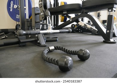 Pull Down Rope Attachment for Cable Machine Workouts. Close-up of a pull-down rope attachment with handles, designed for versatile cable machine exercises like abdominal crunches, push-pull movements,