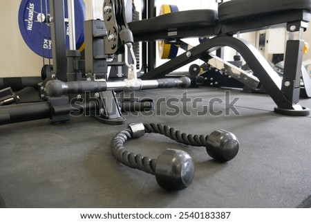Pull Down Rope Attachment for Cable Machine Workouts. Close-up of a pull-down rope attachment with handles, designed for versatile cable machine exercises like abdominal crunches, push-pull movements,