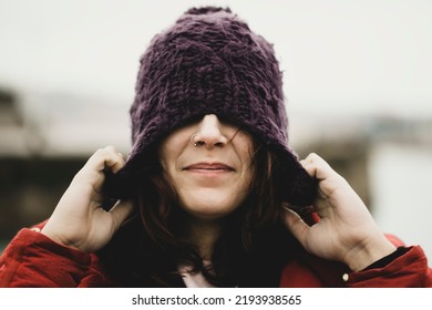 pull head wool cap autumn winter casual woman wearing wool hat outdoors hiding her eyes under fashion knitted cap. Winter wool hat and septum piercing. hat for the cold. Protect hair the cold - Shutterstock ID 2193938565