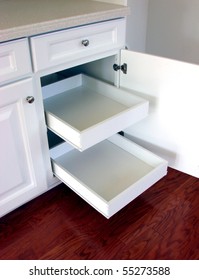 Pull Out Shelf Drawers On White Laminated Cabinets In A Contemporary American House Kitchen