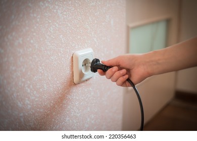 Pull The Plug Concept With Woman Pulling Black Cord And Plug