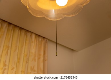 A Pull String Hanging From A Lighting Fixture