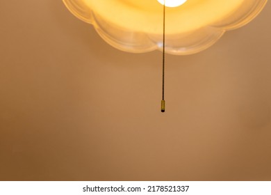 A Pull String Hanging From A Lighting Fixture