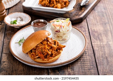 Pulled Bbq Chicken Sandwich On A Brioche Bun Served With Cole Slaw And Bbq Sauce