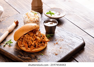 Pulled Bbq Chicken Sandwich On A Brioche Bun Served With Cole Slaw And Bbq Sauce