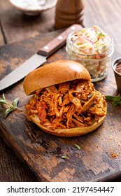 Pulled Bbq Chicken Sandwich On A Brioche Bun Served With Cole Slaw And Bbq Sauce