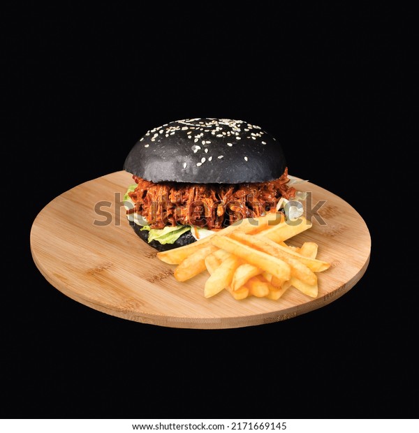 Pulled Brisket black\
Burger with french fries served on wooden board side view on black\
background fast food