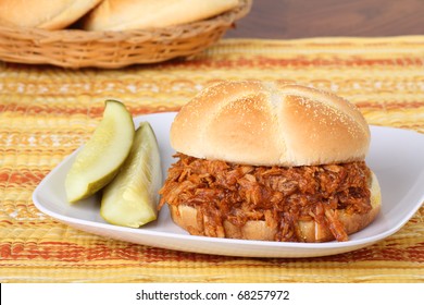 Pulled Pork Barbecue Sandwich And Pickles On A Plate