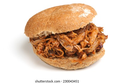 Pulled pork with barbeque sauce in a soft bread roll.