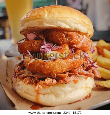Pulled Pork Burger served with thickly cut beefsteak fries, traditionally on parchment. Isolated on a brown background. Close-up. Macro. American cuisine.