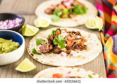 Pulled Pork Carnitas With Pico De Gallo On A Flour Tortilla.