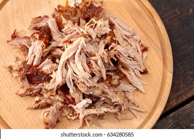 Pulled pork on round wooden board