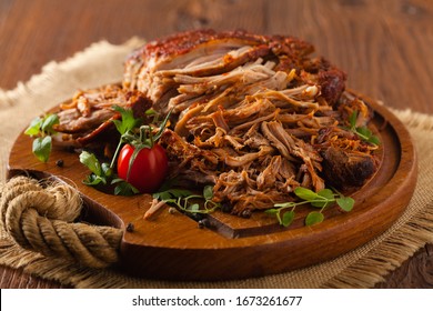 Pulled pork on a wooden board.