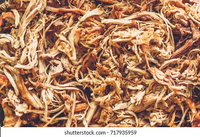 Pulled pork from oven in glass bowl ready for serving. Home made pulled pork made in house oven, smoker or barbecue bbq is ready to be eaten.