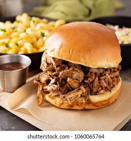 Pulled pork sandwich with bbq sauce on the table