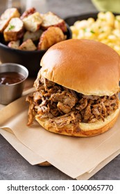 Pulled Pork Sandwich With Bbq Sauce On The Table