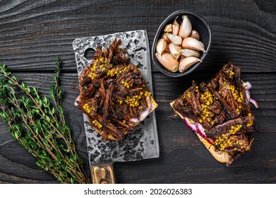 Pulled Pork Sandwich With Smoked Pork Meat On A Meat Cleaver. Black Wooden Background. Top View