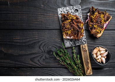 Pulled Pork Sandwich With Smoked Pork Meat On A Meat Cleaver. Black Wooden Background. Top View. Copy Space