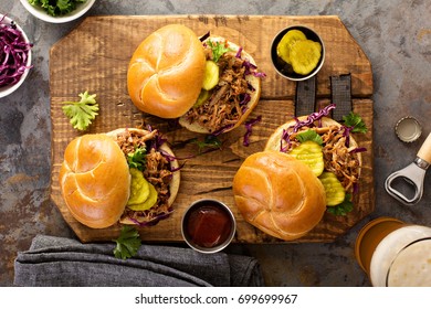 Pulled Pork Sandwiches With BBQ Sauce, Cabbage And Pickles Overhead Shot