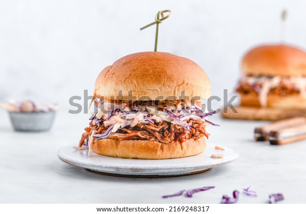 Pulled pork sliders with coleslaw, buns and\
seasoning. Pulled pork burgers.\
