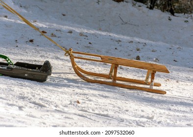 Pulling Empty Wooden Sled Uphill On A Sunny Winter Day