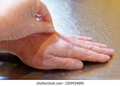 Pulling The Skin Up On The Back Of The Hand To Test The Skin Turgor, Checking Symptoms Of Dehydration