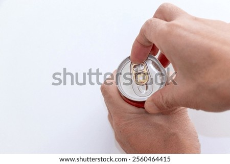 Pulling the tab on a can of drink