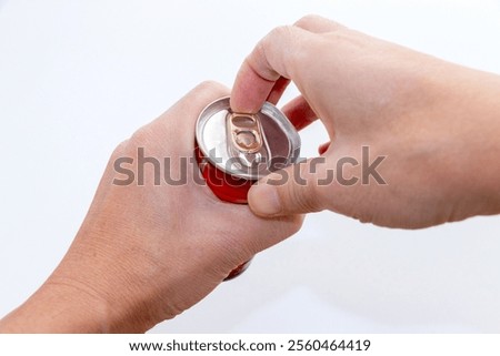 Pulling the tab on a can of drink