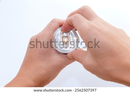 Pulling the tab on a can of drink