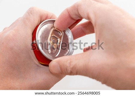 Pulling the tab on a can of drink