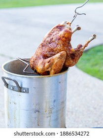 Pulling A Whole Deep Fried Turkey Out Of The Fryer