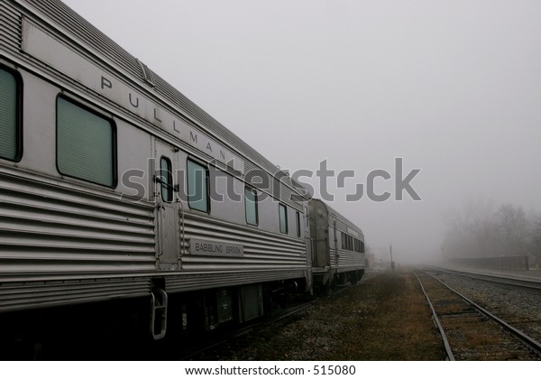 Pullman railroad sleeper\
cars in fog