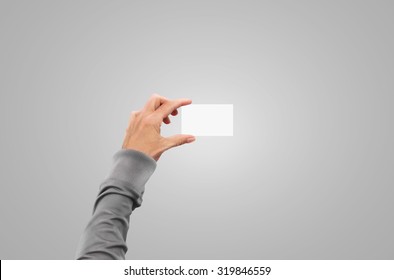 Pullover Hand In Sweater Jacket Hold Business Card Mock Up In Arm. Hands With Sleeve Slip-on Holding Paper Identity Mockup Presentation In Fingers. Isolated On Gray Background. Card Document Holder.