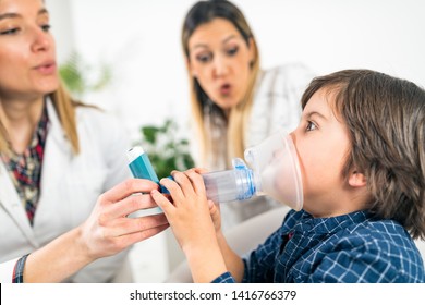 Pulmonology Doctor Helping Little Boy With Inhaler