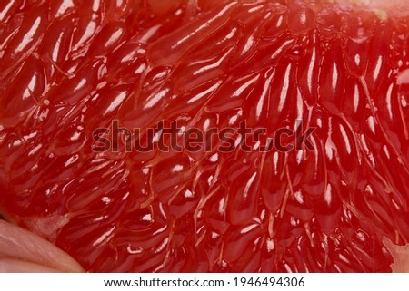The pulp of a red grapefruit close-up. Closeup. Grapefruit fibers in high magnification.