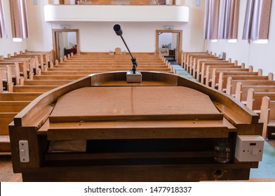 Pulpit at the a church with wooden pews - Shutterstock ID 1477918337