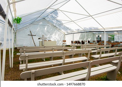 Pulpit, Cross And Benches At A Tent Revival.