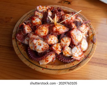 Pulpo a la gallega in Spanish meaning Galician-style octopus or polbo a feira meaning fair-style octopus in gallego.  - Shutterstock ID 2029763105